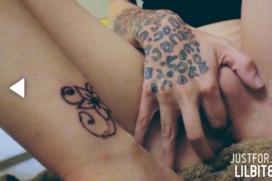 Tattooed girl fingering pussy