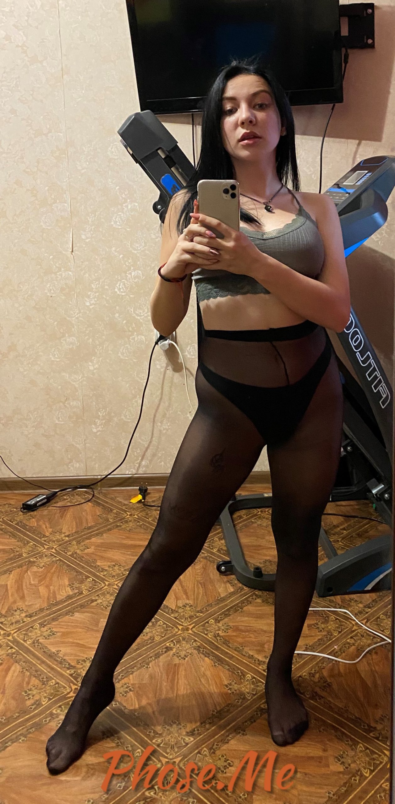 Brunette in black pantyhose taking selfie